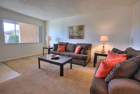 Albuquerque apartment for rent - A living room with a couch, two chairs, and a coffee table.