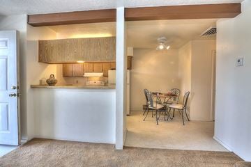 Albuquerque apartment for rent - A kitchen with a dining table and chairs is visible through a doorway.