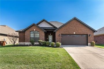 Sellersburg house for rent - a brick house with a driveway and a garage door