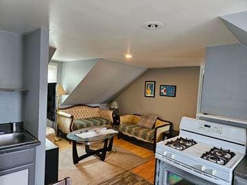 New Bedford apartment for rent - A living room with a couch, a coffee table, and a stove.