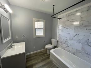 Kelso house for rent - a bathroom with a tub and a sink and a toilet