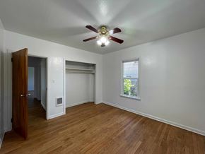 Kelso house for rent - an empty living room with a ceiling fan and a window