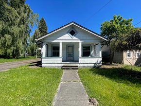 Kelso house for rent - a small white house with a sidewalk in front of it