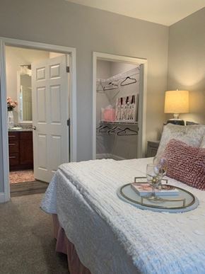 Hickory apartment for rent - a bedroom with a bed and a table with a tray