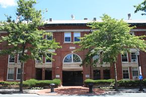 Charlestown apartment for rent - a red brick building with trees in front of it