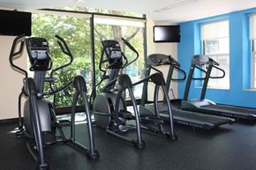 Charlestown apartment for rent - a gym with cardio equipment and a large window