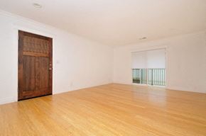 Palo Alto apartment for rent - an empty living room with wooden floors and a wooden door