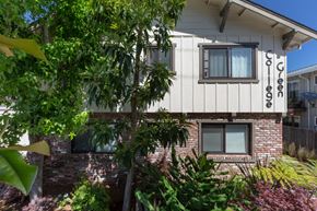 Palo Alto apartment for rent - the side of a house with a brick wall and a tree