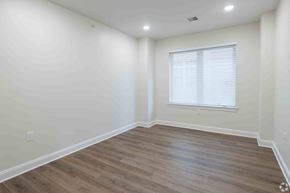 Plainfield apartment for rent - a living room with white walls and wooden floors and a window