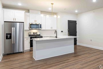 Plainfield apartment for rent - a kitchen with a large island and a stainless steel refrigerator