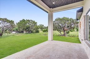 Horseshoe Bay house for rent - a covered patio with a lawn and trees in the background