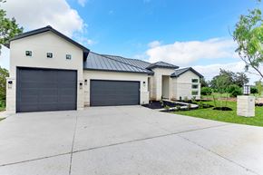 Horseshoe Bay house for rent - a white house with a driveway and a garage door
