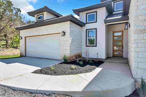 Horseshoe Bay house for rent - a white house with a driveway and a garage door