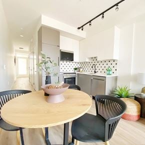 Vancouver apartment for rent - A modern kitchen with a dining table and chairs.