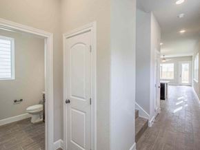 San Antonio apartment for rent - a bathroom with a white door and a toilet in a hallway