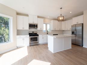 South Bound Brook apartment for rent - A modern kitchen with white cabinets and stainless steel appliances.