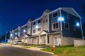 South Bound Brook apartment for rent - A building with blue lights on the front at night.