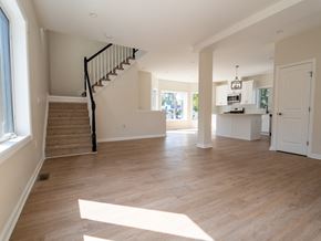 South Bound Brook apartment for rent - A spacious living room with a staircase leading to the upper floor.