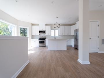 South Bound Brook apartment for rent - A modern kitchen with white cabinets and a wooden floor.