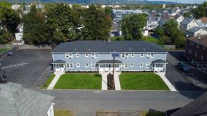 South Bound Brook apartment for rent - A large building with a parking lot in front of it.