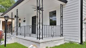 Atlanta apartment for rent - A white house with a black iron fence.