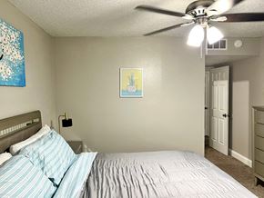 Irving house for rent - a bedroom with a bed and a ceiling fan