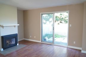 Edmonton apartment for rent - an empty living room with a fireplace and sliding glass doors