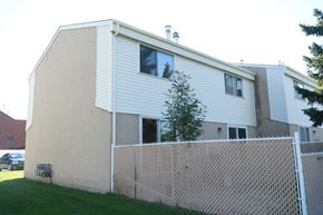 Edmonton apartment for rent - a white house with a fence in front of it