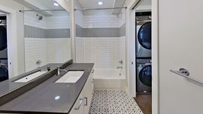Denver house for rent - a bathroom with a sink and a washer and dryer and a laundry room