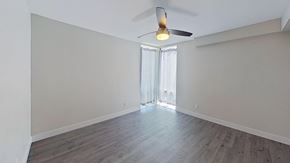Denver house for rent - an empty living room with wood floors and a ceiling fan