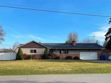 Spokane Valley house for rent - a house with a yard and a white garage door