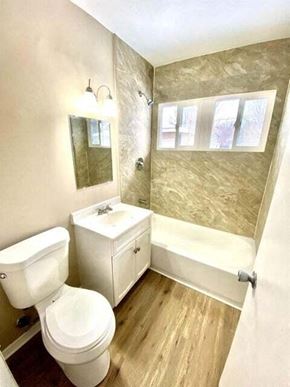 Gary house for rent - a bathroom with a white toilet and a sink