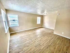 Gary house for rent - an empty living room with a hard wood floor