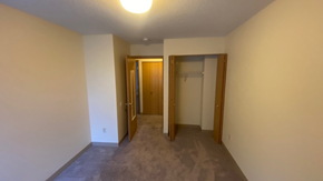 White Bear Lake townhouse for rent - an empty living room with a hallway to a closet and a door to a bathroom