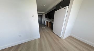 New Rochelle apartment for rent - a renovated apartment with a refrigerator and a kitchen