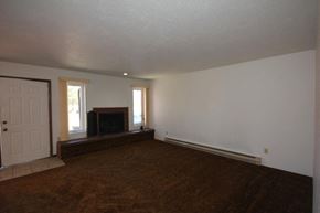 Whitefish apartment for rent - A room with a fireplace and a door.
