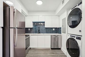 Sunrise apartment for rent - A modern kitchen with a stainless steel refrigerator and a washing machine.