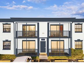 Sunrise apartment for rent - A modern two-story building with a balcony on the second floor.