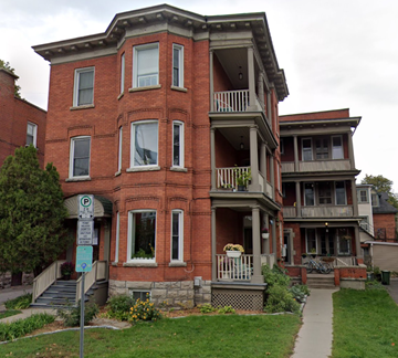 Ottawa apartment for rent - a red brick house with a sidewalk in front of it