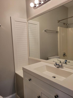 Fort Myers apartment for rent - A white bathroom with a sink and mirror.