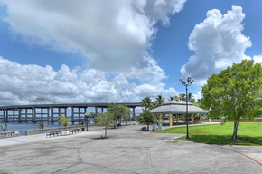Fort Myers apartment for rent - A park with a gazebo, benches, and a bridge in the background.