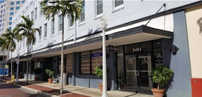 Fort Myers apartment for rent - A white building with a black awning and a sign that reads "NONE" on it.