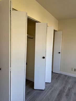 Burnaby apartment for rent - A white door is open to a hallway with a grey floor.