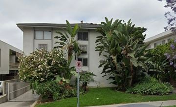 Los Angeles apartment for rent - a white building with palm trees and a no parking sign