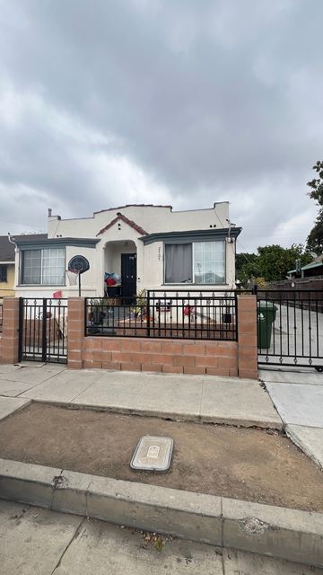 Los Angeles apartment for rent - the front of a house with a sidewalk and a fence