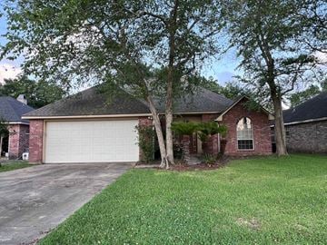 Lafayette house for rent - a brick house with a white garage door