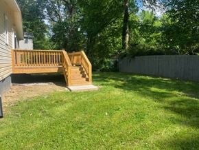 Atlanta house for rent - a backyard with a wooden deck and a fence