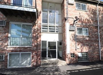 Cincinnati apartment for rent - the outside of a brick building with an open door
