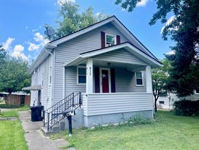 Louisville house for rent - a small white house with a porch and a staircase