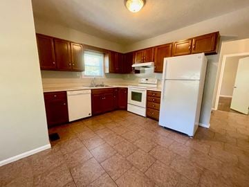 Louisville house for rent - an empty kitchen with a refrigerator and a sink